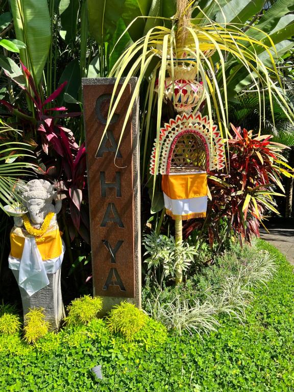 a garden with some plants and a sign and some plants at Cahaya Indah Villas in Ubud