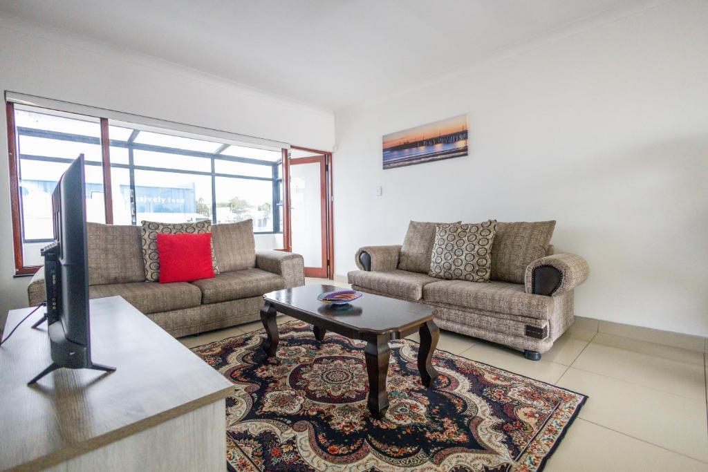 a living room with two couches and a tv at Safi Luxury Apartment 7 in East London