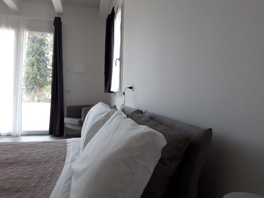 Posteľ alebo postele v izbe v ubytovaní Country House-B&B-Appartamenti Ai Cipressi