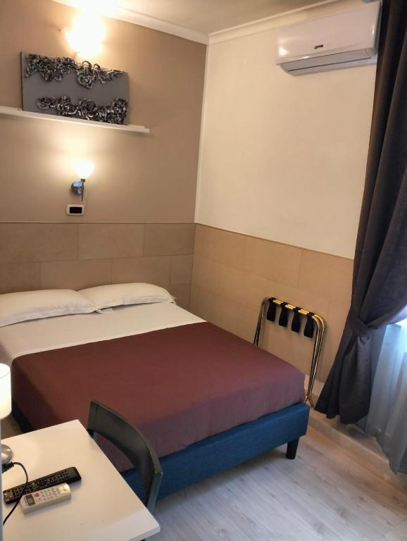 Postel nebo postele na pokoji v ubytování Hotel Indipendenza