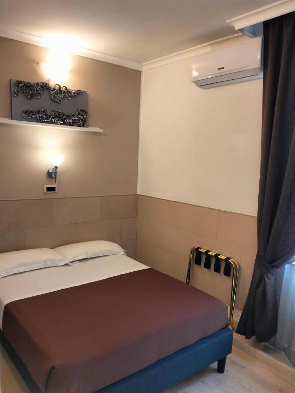 Postel nebo postele na pokoji v ubytování Hotel Indipendenza