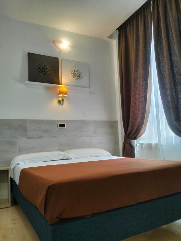 Postel nebo postele na pokoji v ubytování Hotel Indipendenza