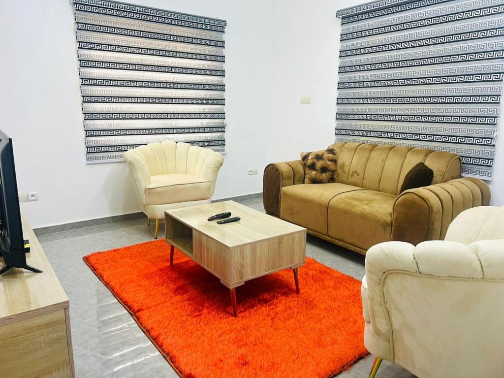 a living room with a couch and a coffee table at Louis Vuitton in Abomey-Calavi