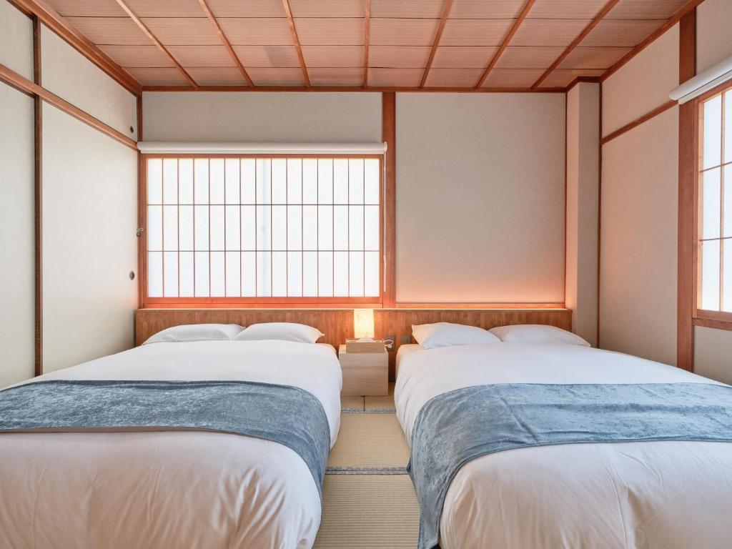 Postel nebo postele na pokoji v ubytování KONJAKUSO Nara Naramachi "MUSHIBUROYA" Sauna Villa