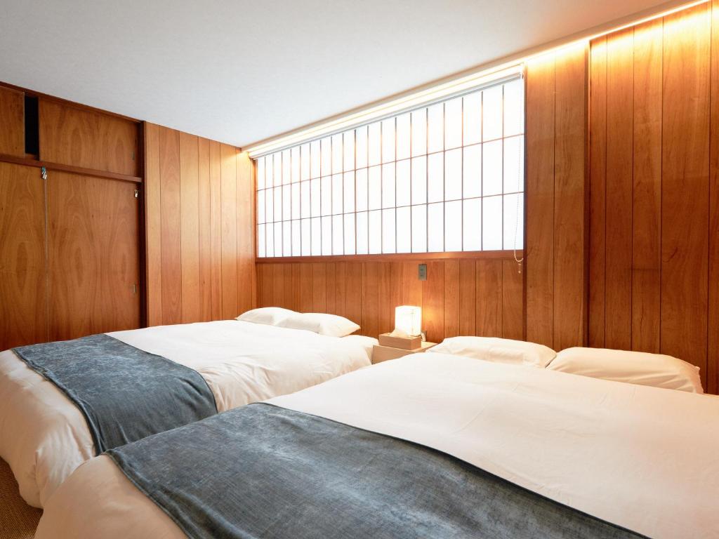 Postel nebo postele na pokoji v ubytování KONJAKUSO Nara Naramachi "MUSHIBUROYA" Sauna Villa