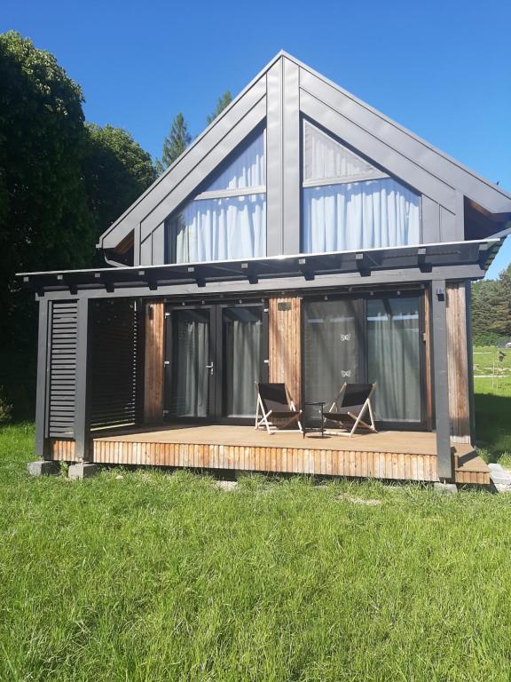 a house with two chairs on a deck at Love Wysove in Wysowa-Zdrój