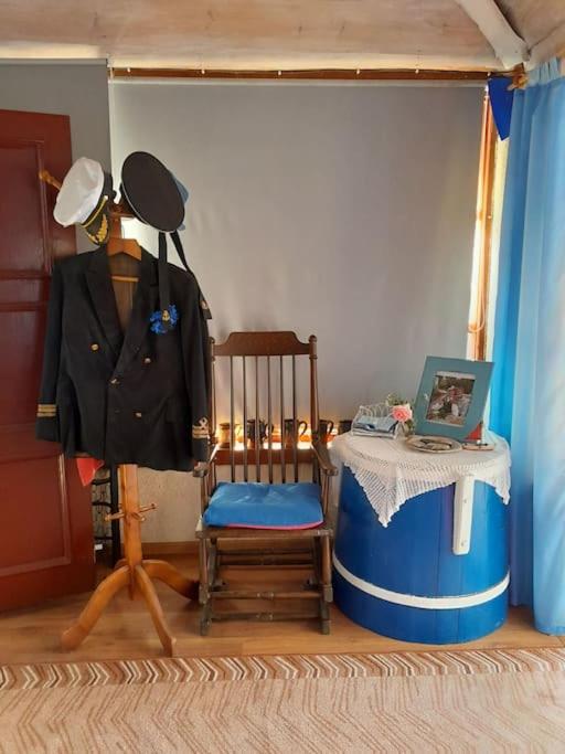 a room with a mannequin and a chair and a table at Pie Garozas in Lapmežciems