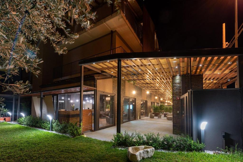 a house with a glass extension at night at Corten Hotel in Santa Maria di Licodia