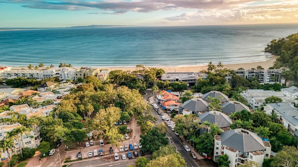 an aerial view of a city and the beach at Ocean Breeze Resort in Noosa Heads