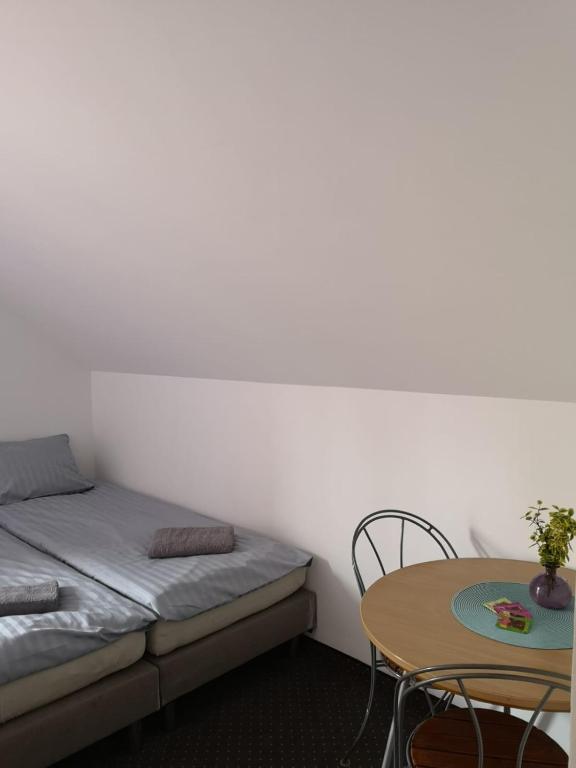 Cozy bedroom with twin beds and a small dining table.