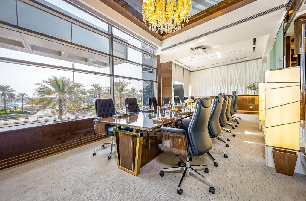 an office with a long table and chairs and a large window at Golden Sands Boutique Hotel-Dubai Creek in Dubai