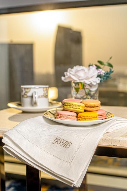a plate of cookies on a table with a napkin at Golden Sands Boutique Hotel-Dubai Creek in Dubai