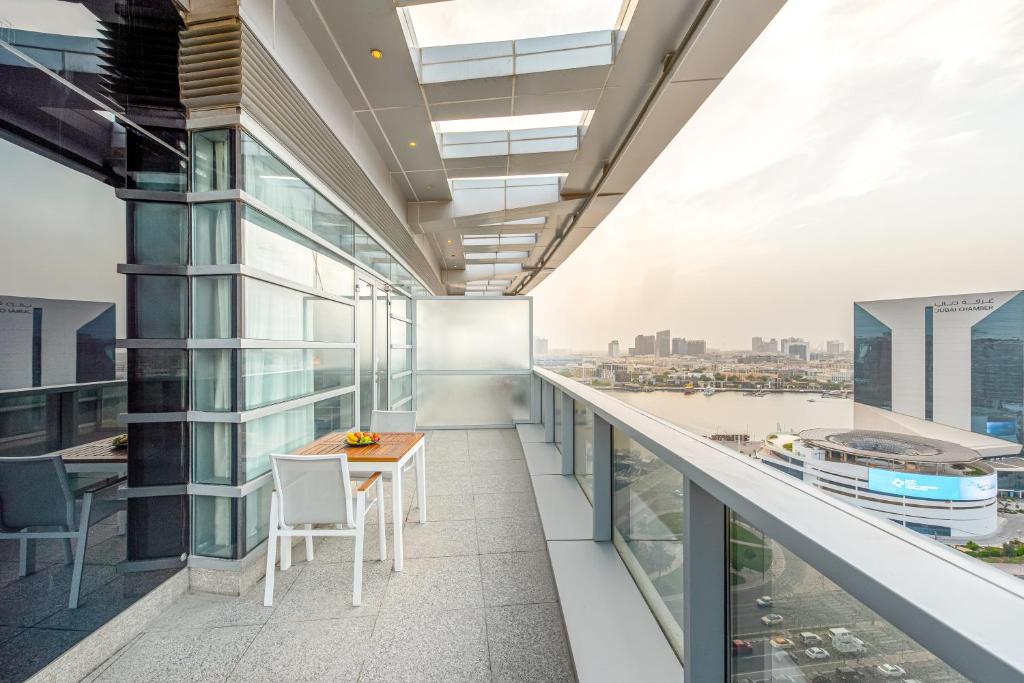 a balcony with a table and chairs on a building at Golden Sands Boutique Hotel-Dubai Creek in Dubai