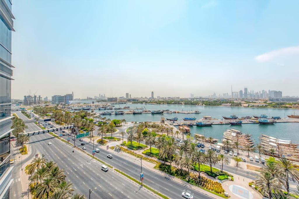 a view of a city with a river and buildings at Golden Sands Boutique Hotel-Dubai Creek in Dubai