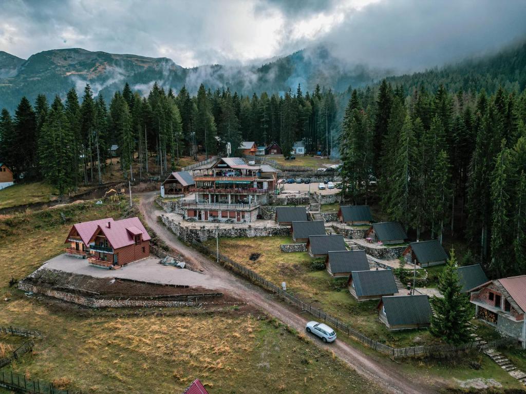 an aerial view of a village in the mountains at Hotel Te Liqeni in Peje