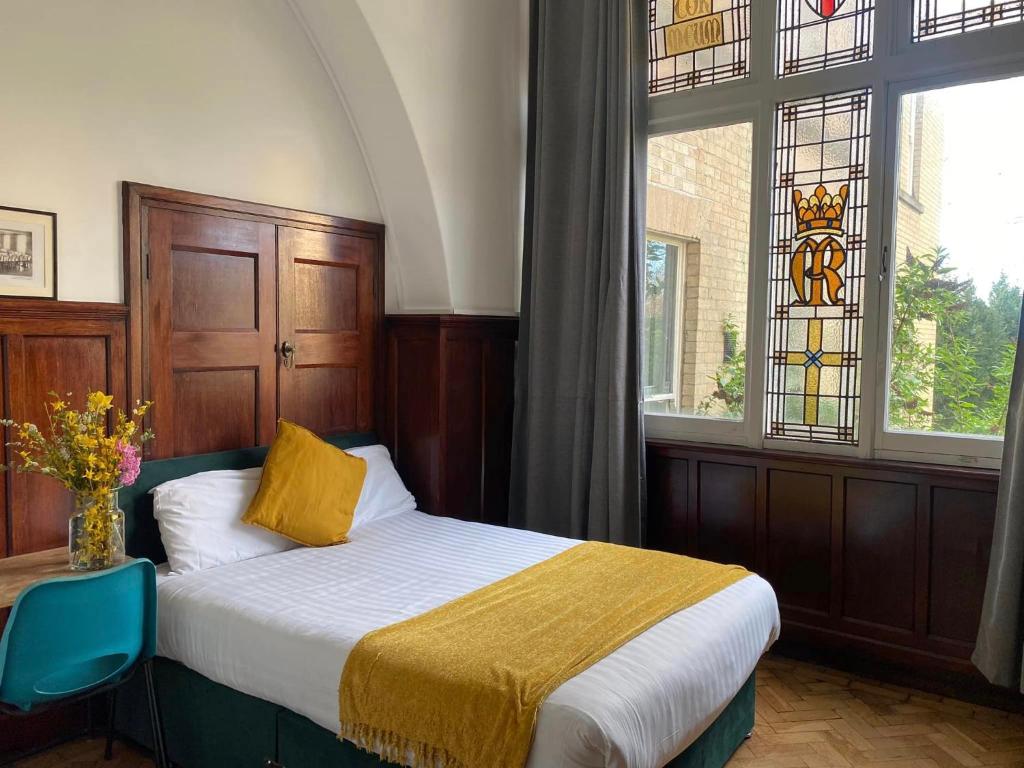 a bedroom with a bed and a stained glass window at Endsleigh Park in Hull