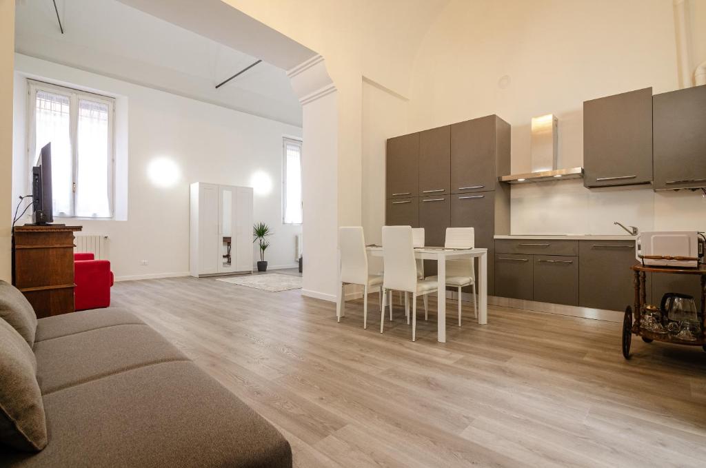 een woonkamer met een tafel en een keuken bij San Giorgio Loft in Bologna