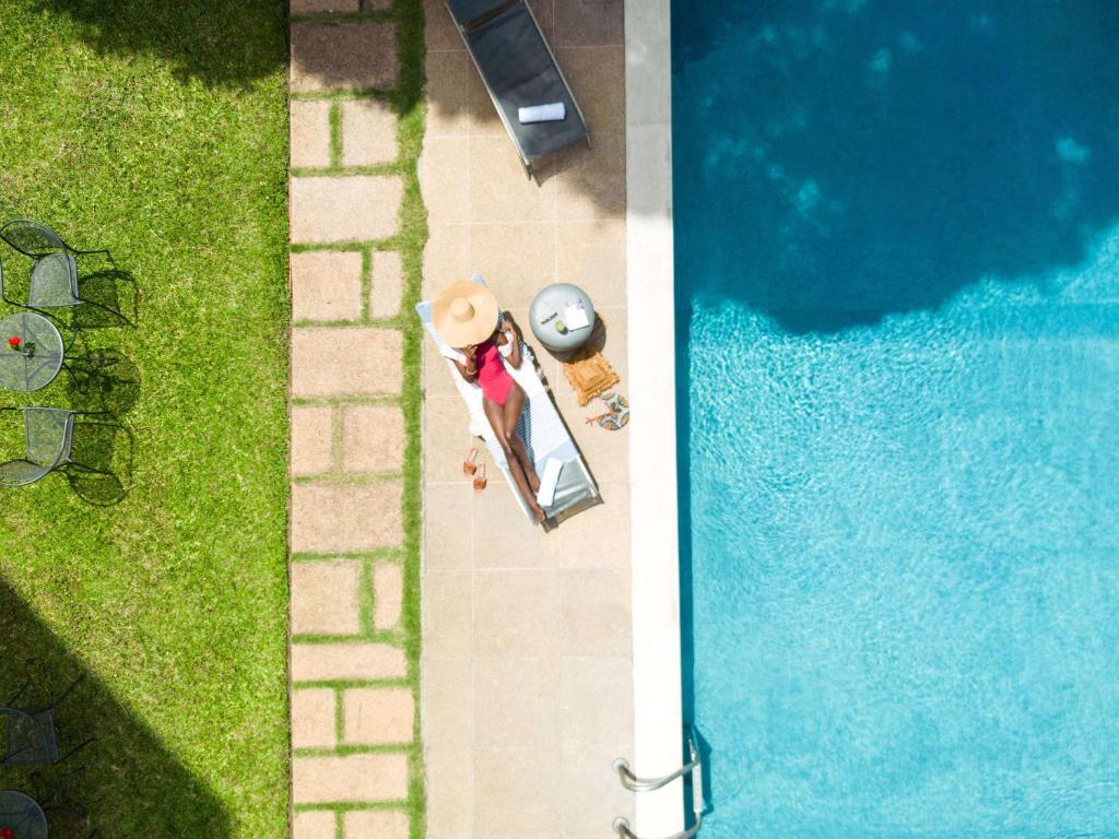 an overhead view of a pool with a person standing next to it at Ibis Styles Abidjan Marcory in Abidjan
