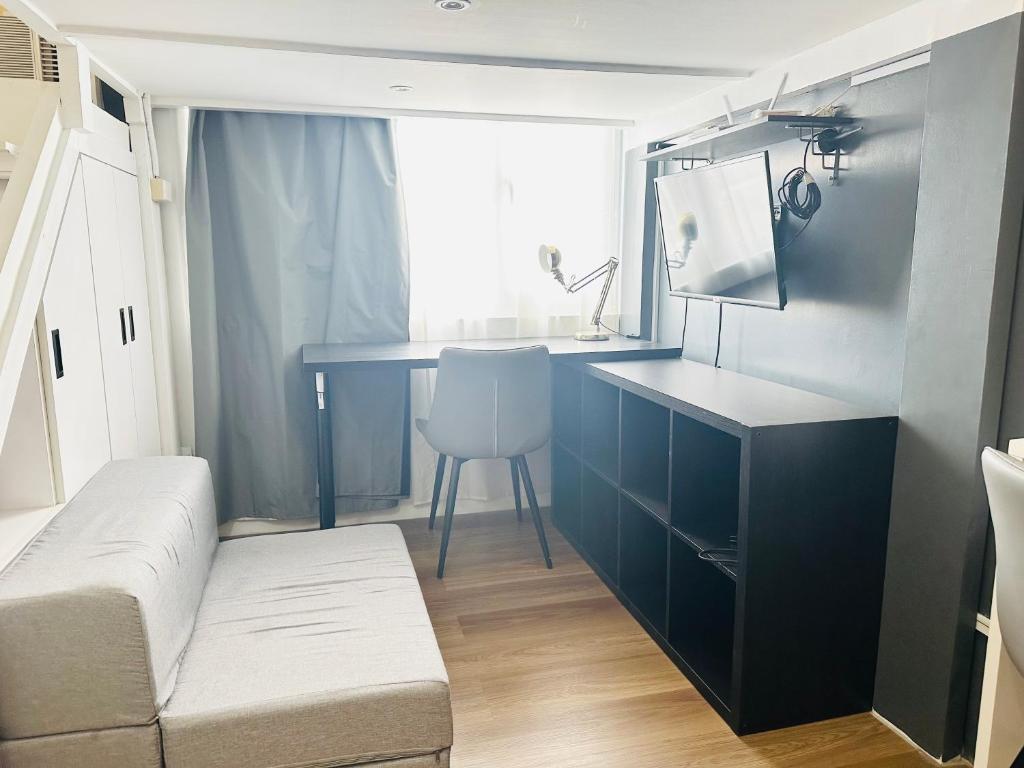 a small room with a desk and a chair at Loft-Style Condo @ Avida Towers with Wifi in Davao City