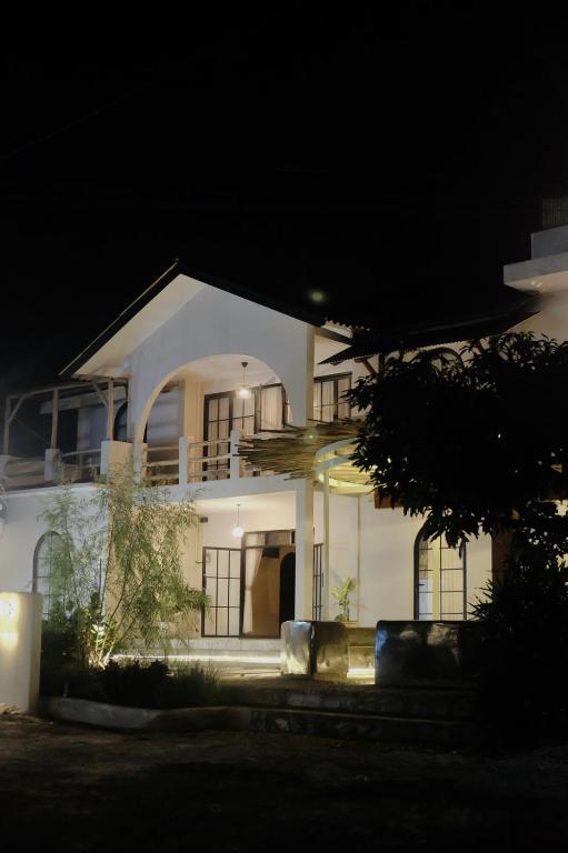 a large white house at night with lights at Sora Boutique Stay in Ciwidey