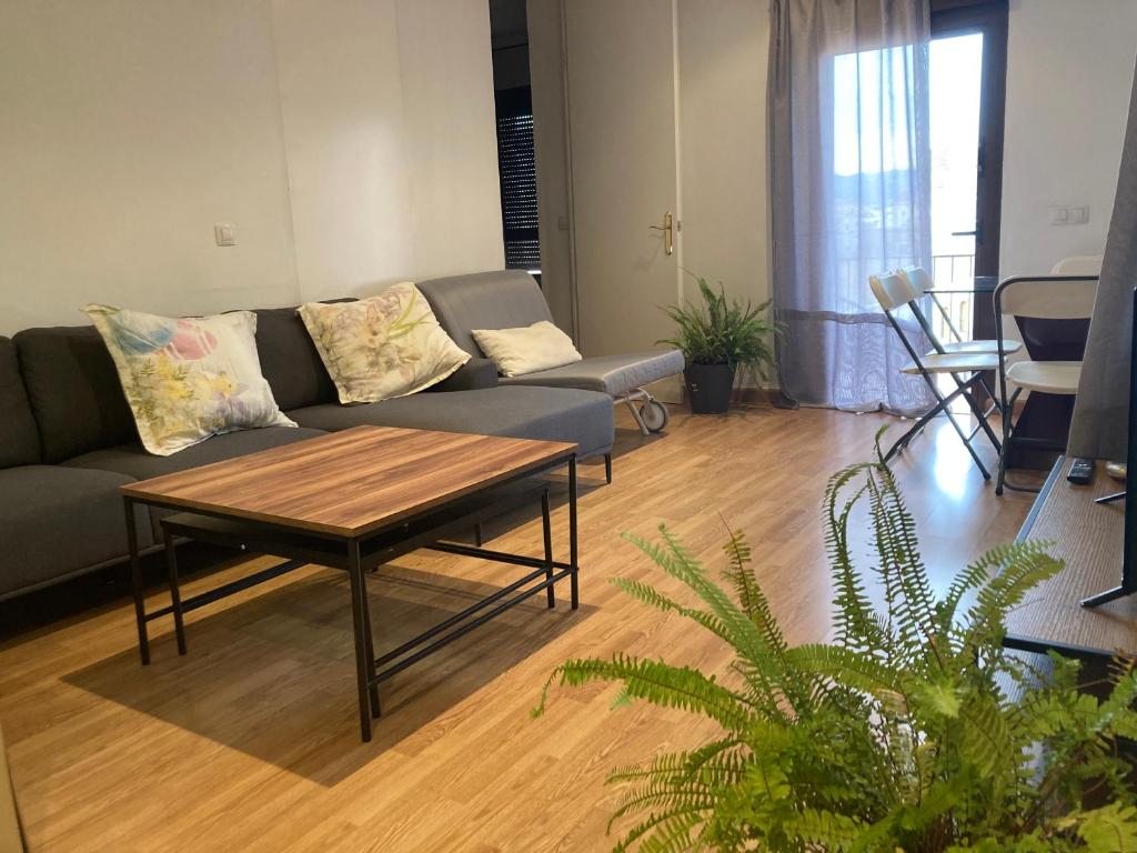 a living room with a couch and a coffee table at Ático dos dormitorios en el centro de Córdoba in Córdoba