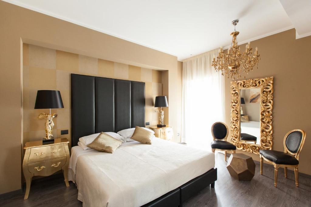 a bedroom with a large bed and a mirror at Town House Roma in Rome