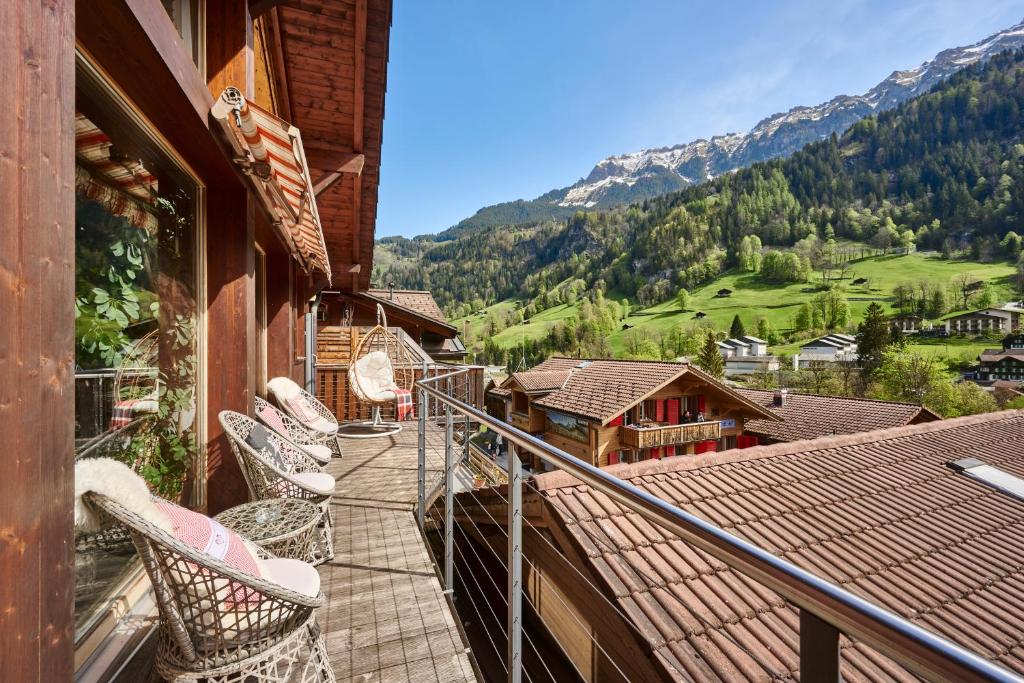 a balcony with chairs and a view of a mountain at Chalet Lauterbrunnen in Lauterbrunnen
