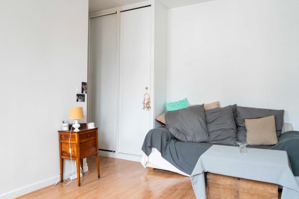 a living room with a couch and a table at Cozy studio 2 steps from the Eiffel Tower in Paris