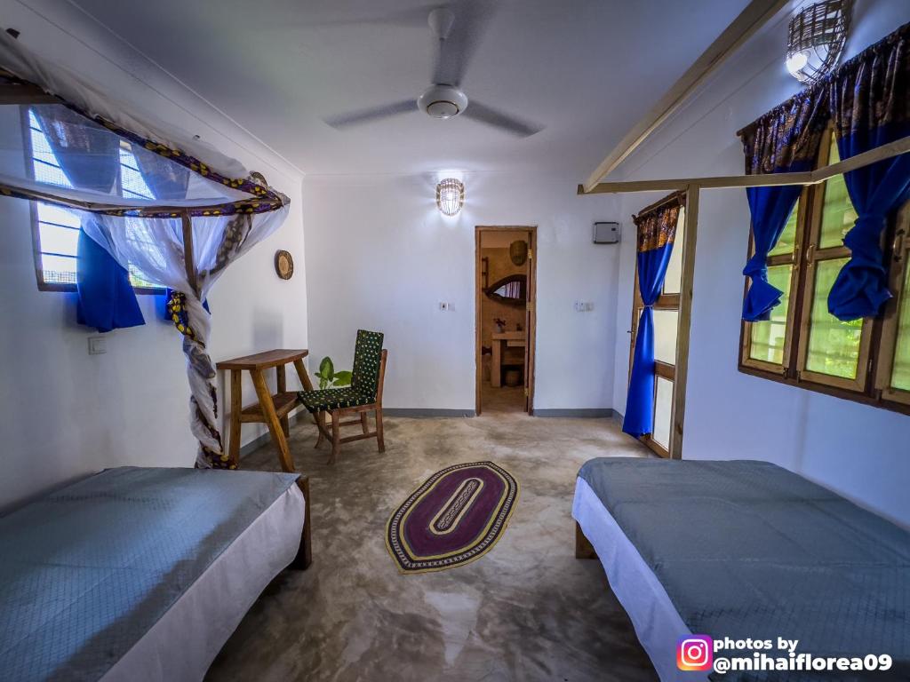 Postel nebo postele na pokoji v ubytování Tofauti Inn