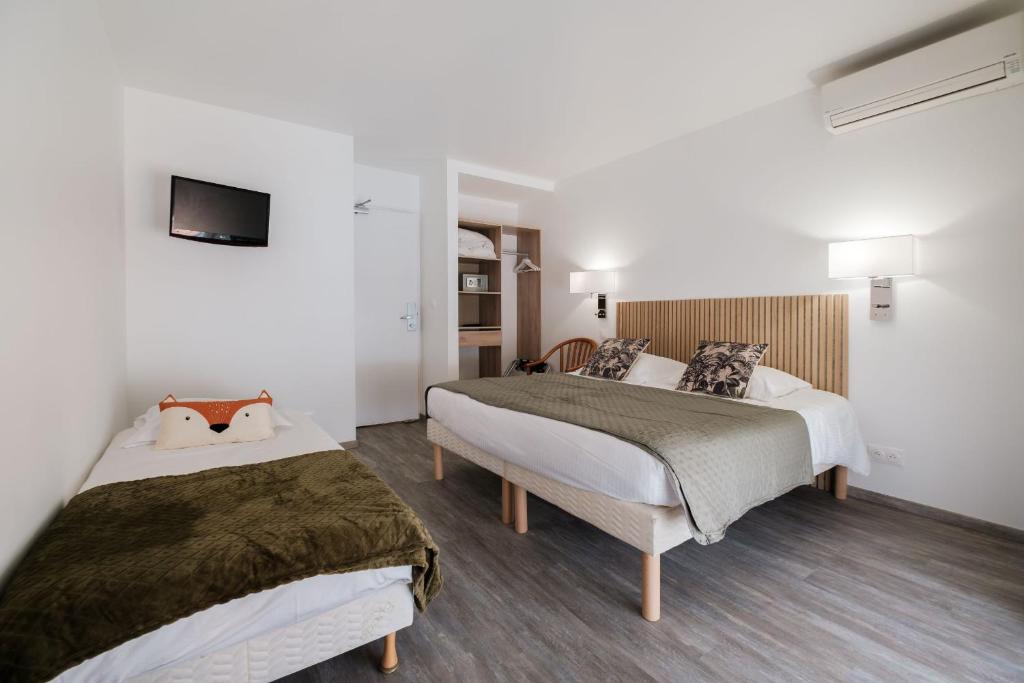 Postel nebo postele na pokoji v ubytování Anglade Hotel