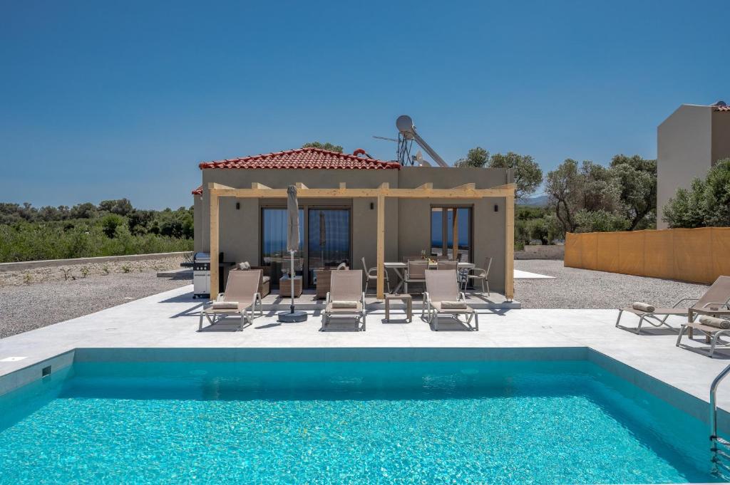 a villa with a swimming pool and a house at Meli & Gio 2 in Viranepiskopí