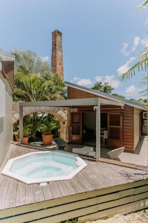 a hot tub on the deck of a house at Habitation TABANON in Petit-Bourg