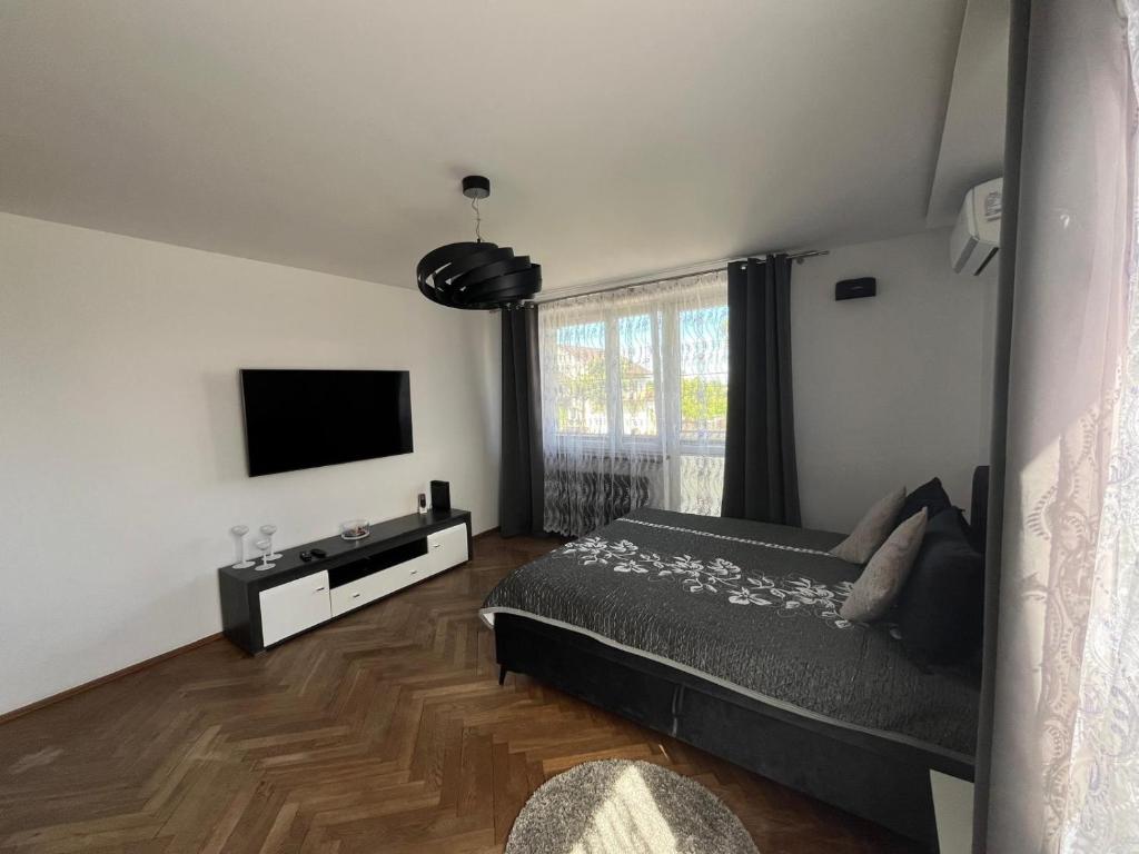a bedroom with a bed and a flat screen tv at Apartament Night Premium Krakow in Krakow