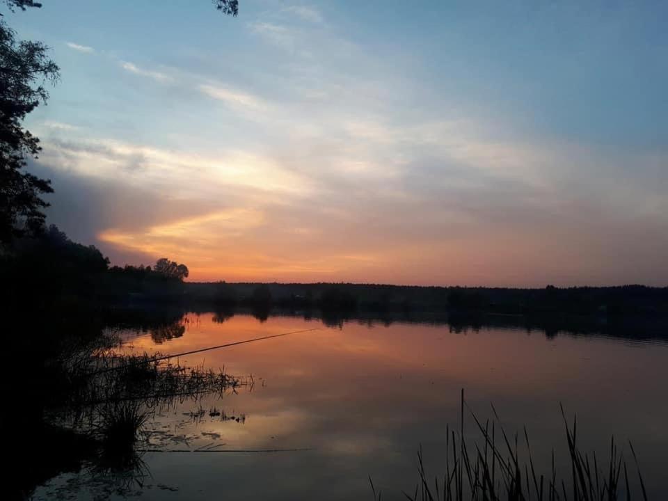 a body of water with a sunset in the background at Садиба «Полісся» in Rudnya Vorobʼivsʼka
