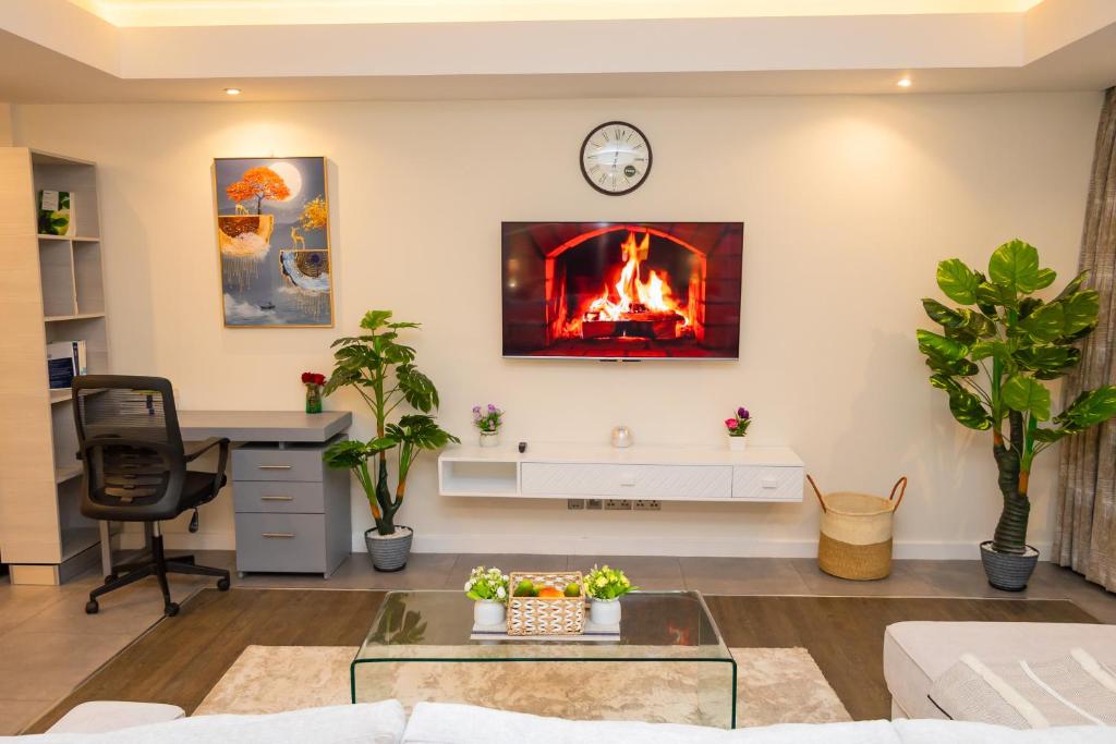 a living room with a fire in the wall at Capital M - Bednbeyond, Westlands Nairobi, Kenya-Call 25472I95O319 in Nairobi
