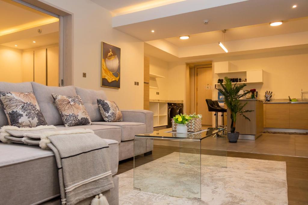 a living room with a couch and a table at Capital M by BednBeyond Dehali Line, Westlands Nairobi, Kenya in Nairobi