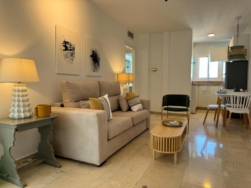 a living room with a couch and a table at Apartamento Las Teresas Khalifa in Córdoba