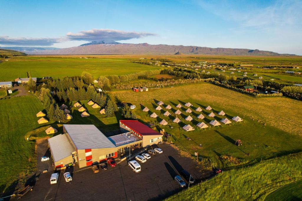 an aerial view of a farm with cars parked in a field at Godaland Glamping in Hvolsvöllur