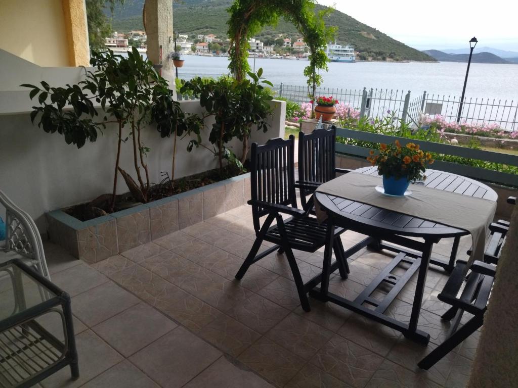 a patio with a table and chairs and a view of the water at Blue Dreams in Almiropotamos