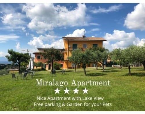 a house in a field with a sign in front of it at Nice apartments lake view & free parking in Pastrengo