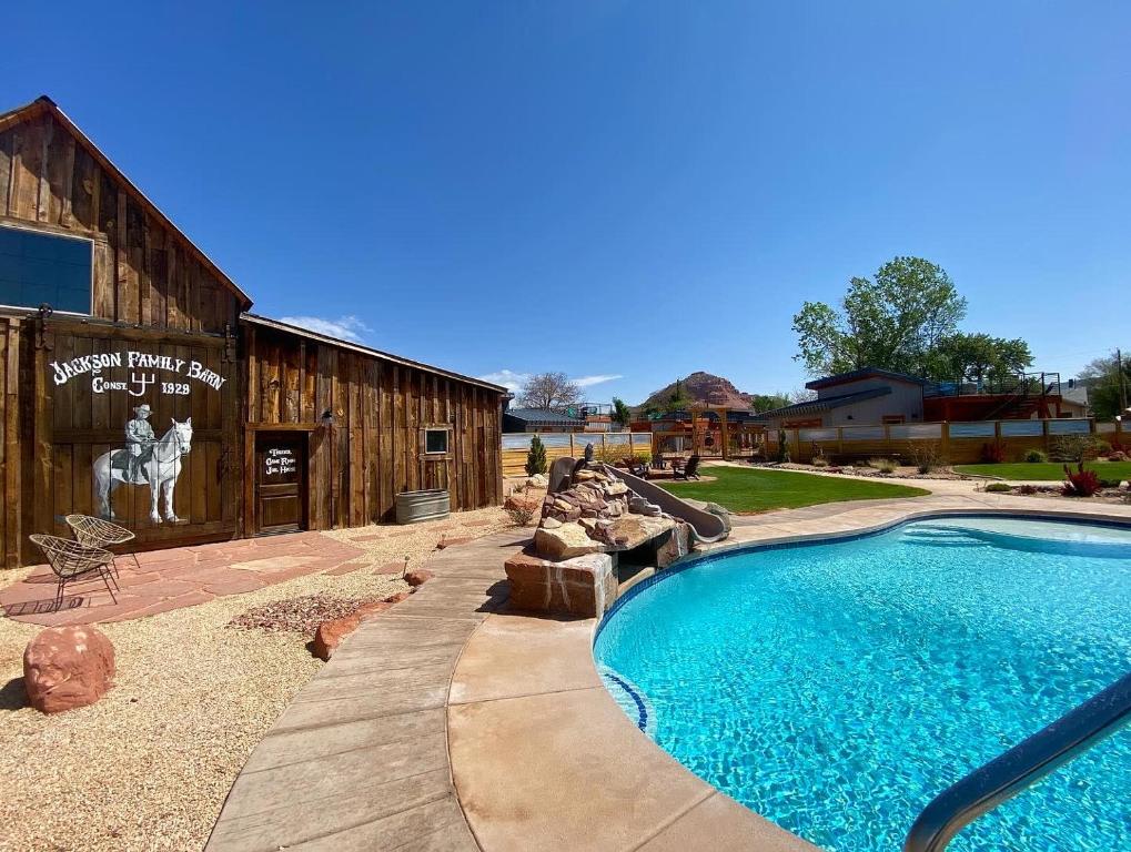 a swimming pool in front of a building at Timber & Tin G 2Bed 2Bath w Pool & Rooftop Deck in Kanab