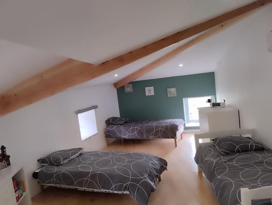 A bed or beds in a room at Le Nolan