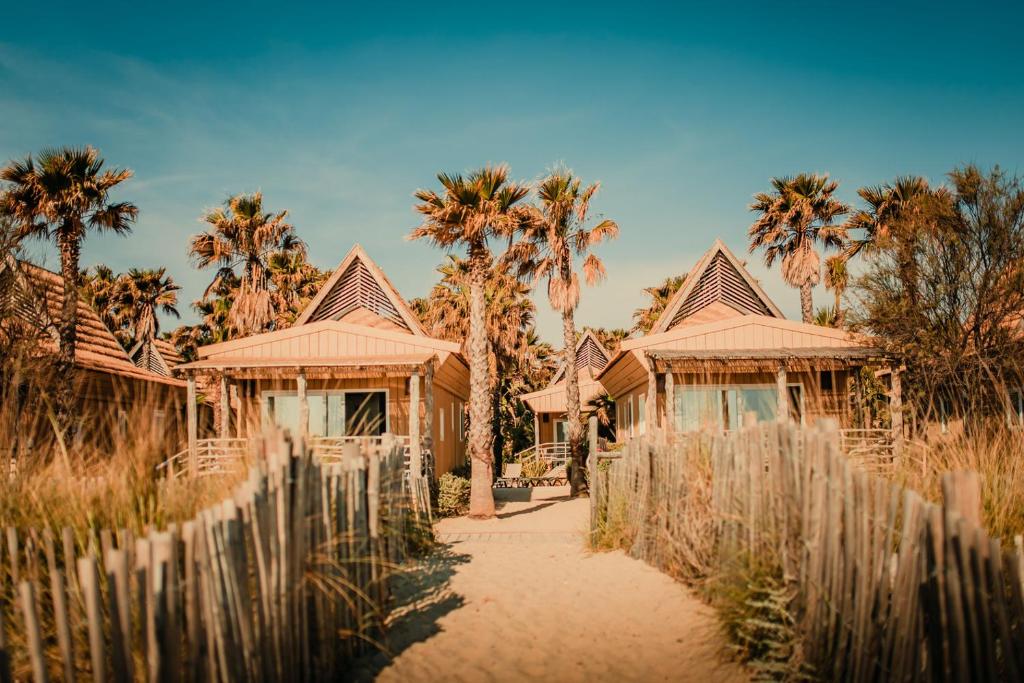 a house with palm trees and a fence at Toison D'or in Saint-Tropez