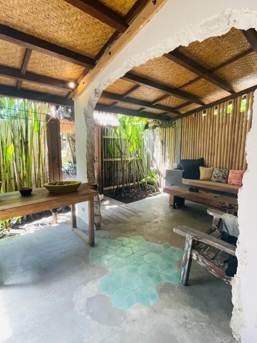 a living room with a table and a bench at Studio On Air in Gili Islands
