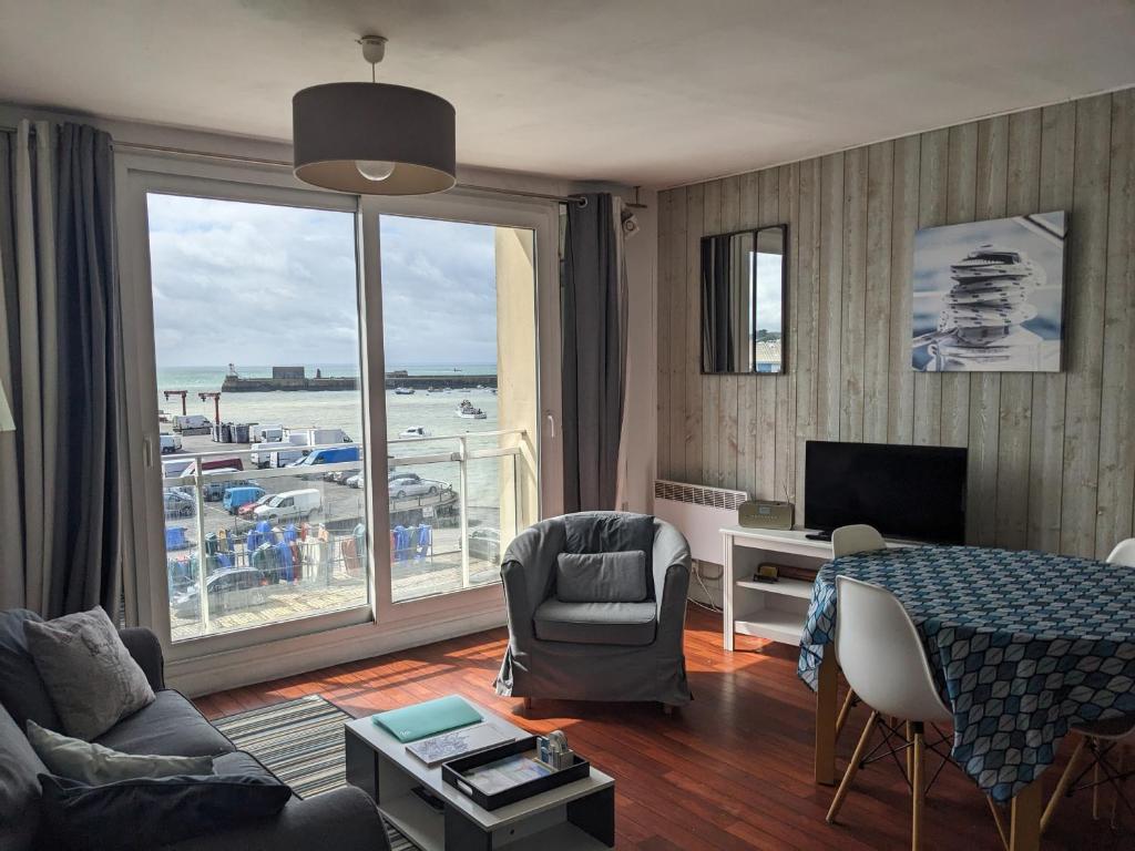 a living room with a view of the ocean at La Vigie sur le Port in Granville