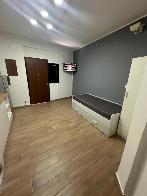 a room with a bed and a tv on a wall at HOUSE SAN FILIPPO in Naples