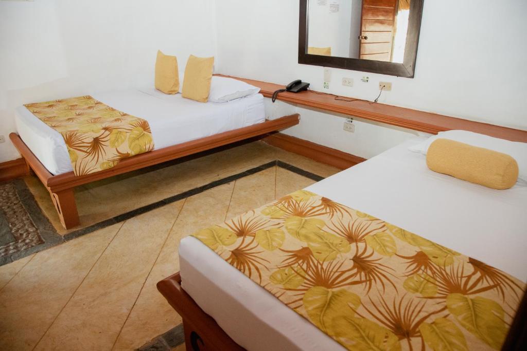 Postel nebo postele na pokoji v ubytování Hotel Portón del Sol
