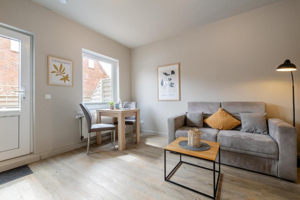 a living room with a couch and a table at Appartement Krabbe - Haus Neptun in Westerland (Sylt)
