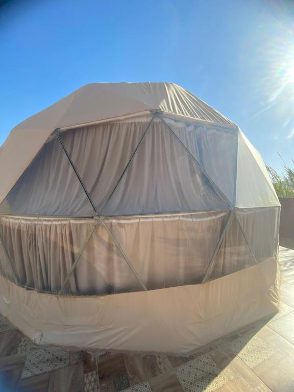 a large tent sitting on top of a patio at King desert in Disah