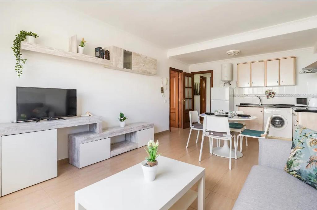 a living room and kitchen with a couch and a table at A 20 metri dalla Spiaggia in Puerto del Rosario